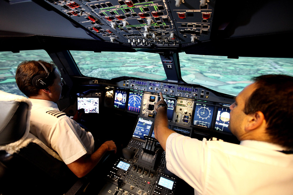 Two British Airways pilots on a simulator flight deck